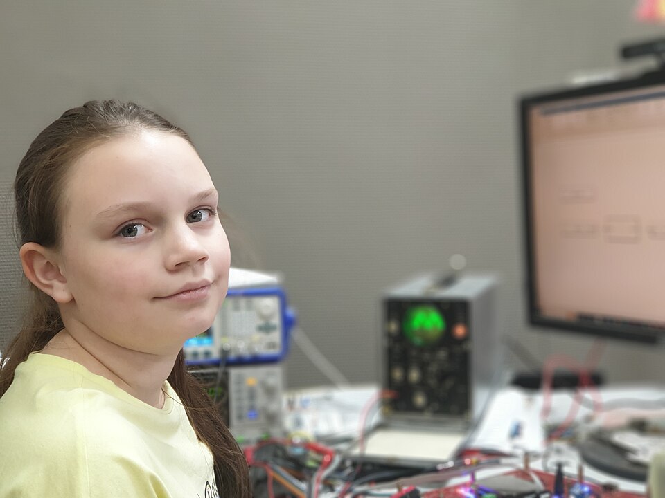 Young scientist (schoolgirl) works with laboratory equipment.jpg